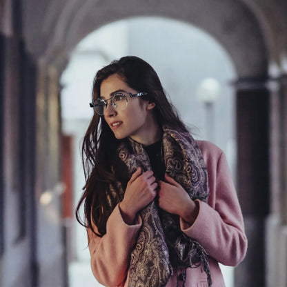 Model wearing Barledear Midnight Marble eyeglasses in a lifestyle portrait showing black white retro round titanium frame style