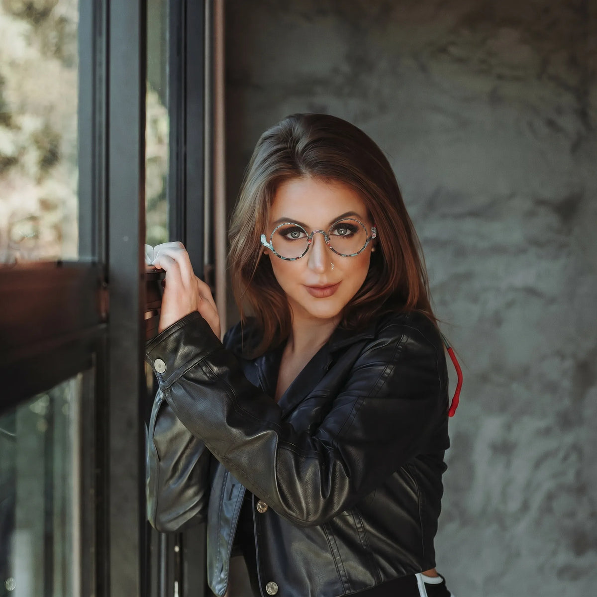 Model wearing Barledear Mosaic Jade eyeglasses in a lifestyle portrait showing the artistic round pure titanium frame on the face