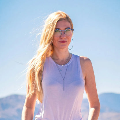 Model wearing Barledear Ocean Marble eyeglasses in a lifestyle portrait showing blue retro round titanium frame style