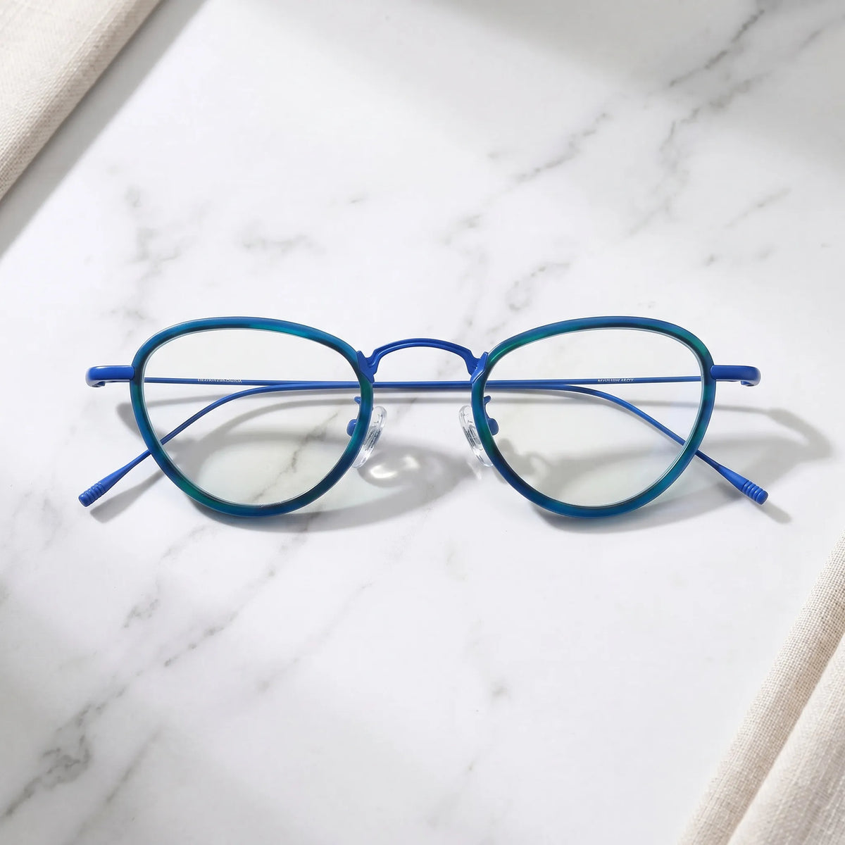 Barledear Ocean Teal eyeglasses folded display showing teal acetate front and slim blue titanium temples