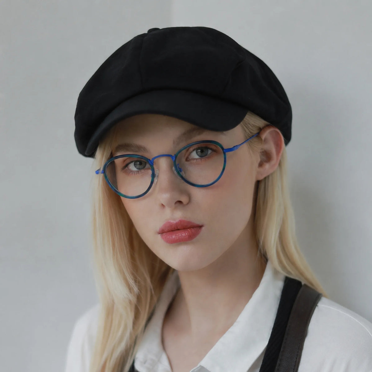 Model wearing Barledear Ocean Teal eyeglasses in a lifestyle portrait with fresh colorful geometric frame styling