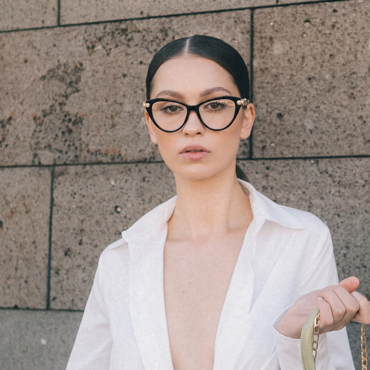 Adult woman wearing Barledear Onyx Black geometric cat-eye eyeglasses in a bold fashion-forward lifestyle portrait