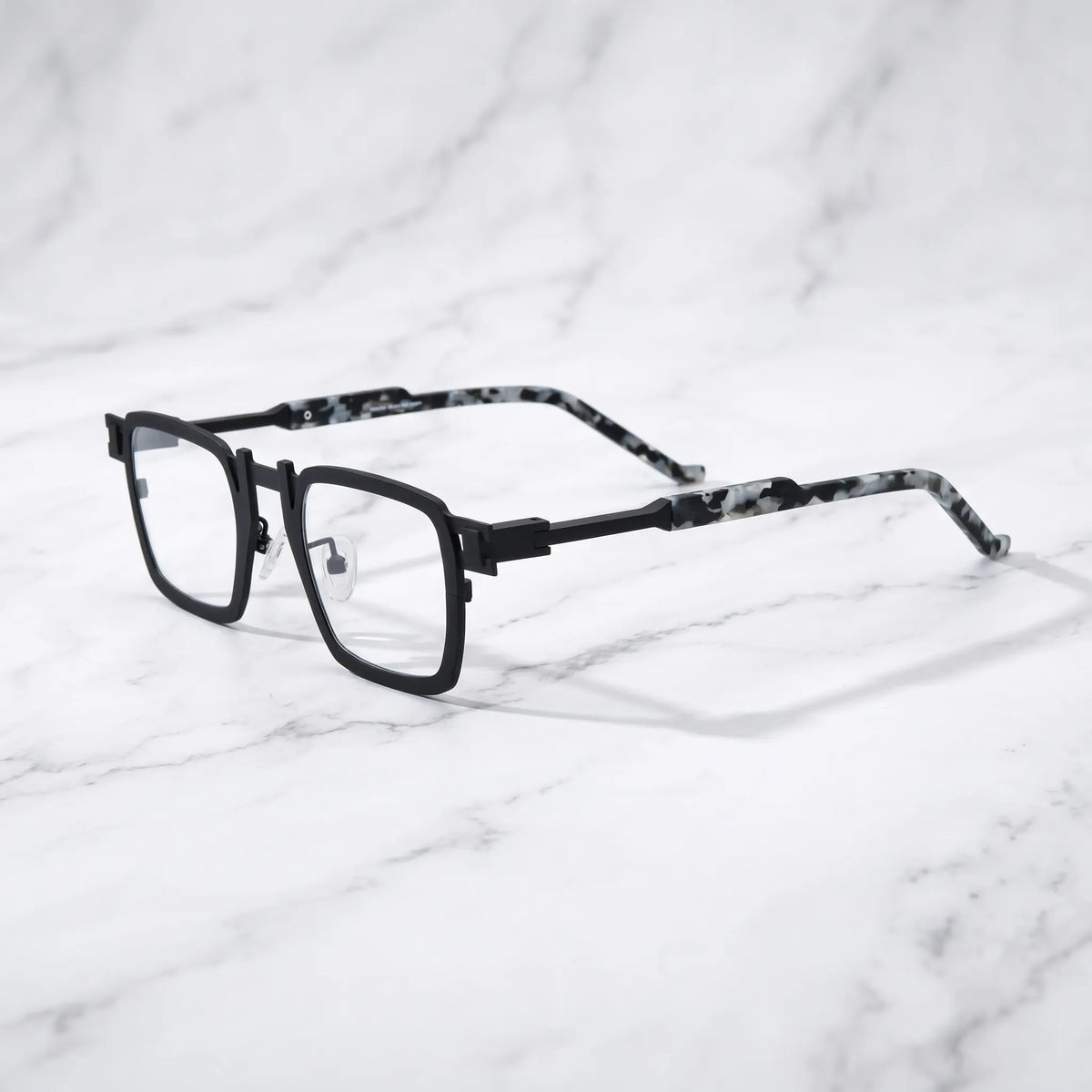 Barledear Onyx Smoke Marble eyeglasses angled side view showing slim titanium temples, geometric side joint, and adjustable nose pads