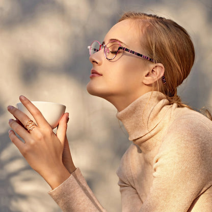 Model wearing Barledear Orchid Blush oval titanium eyeglasses in a lifestyle portrait
