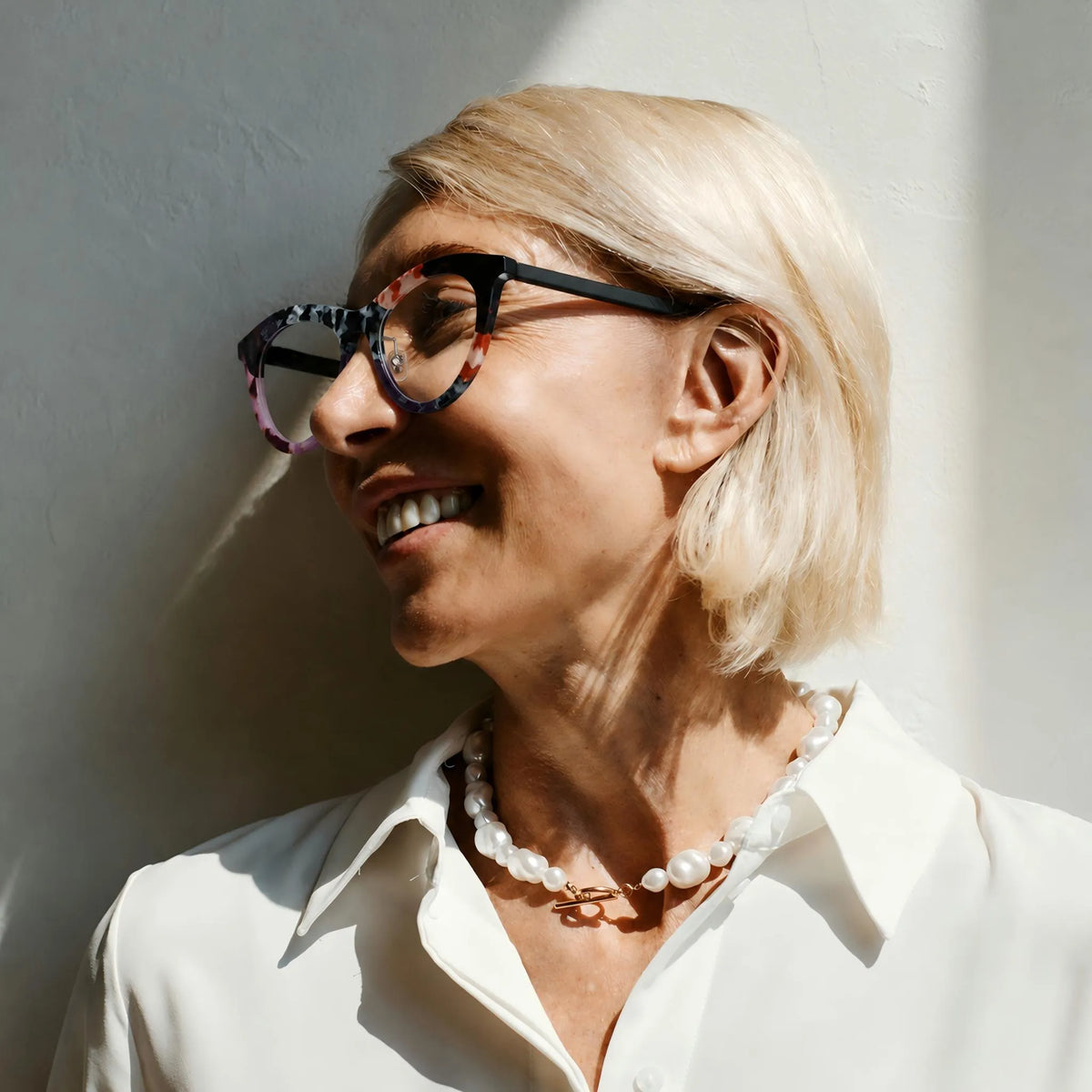 Model wearing Barledear Plum Ember Mosaic cat-eye acetate eyeglasses in a front-facing lifestyle portrait