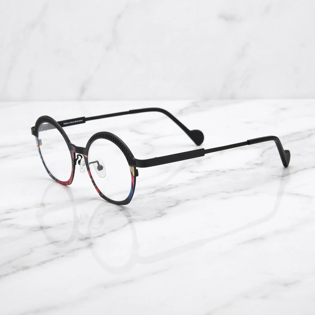 Barledear Prism Noir eyeglasses angled side view showing slim titanium temples, curved black temple tips, and colorful mosaic front detail