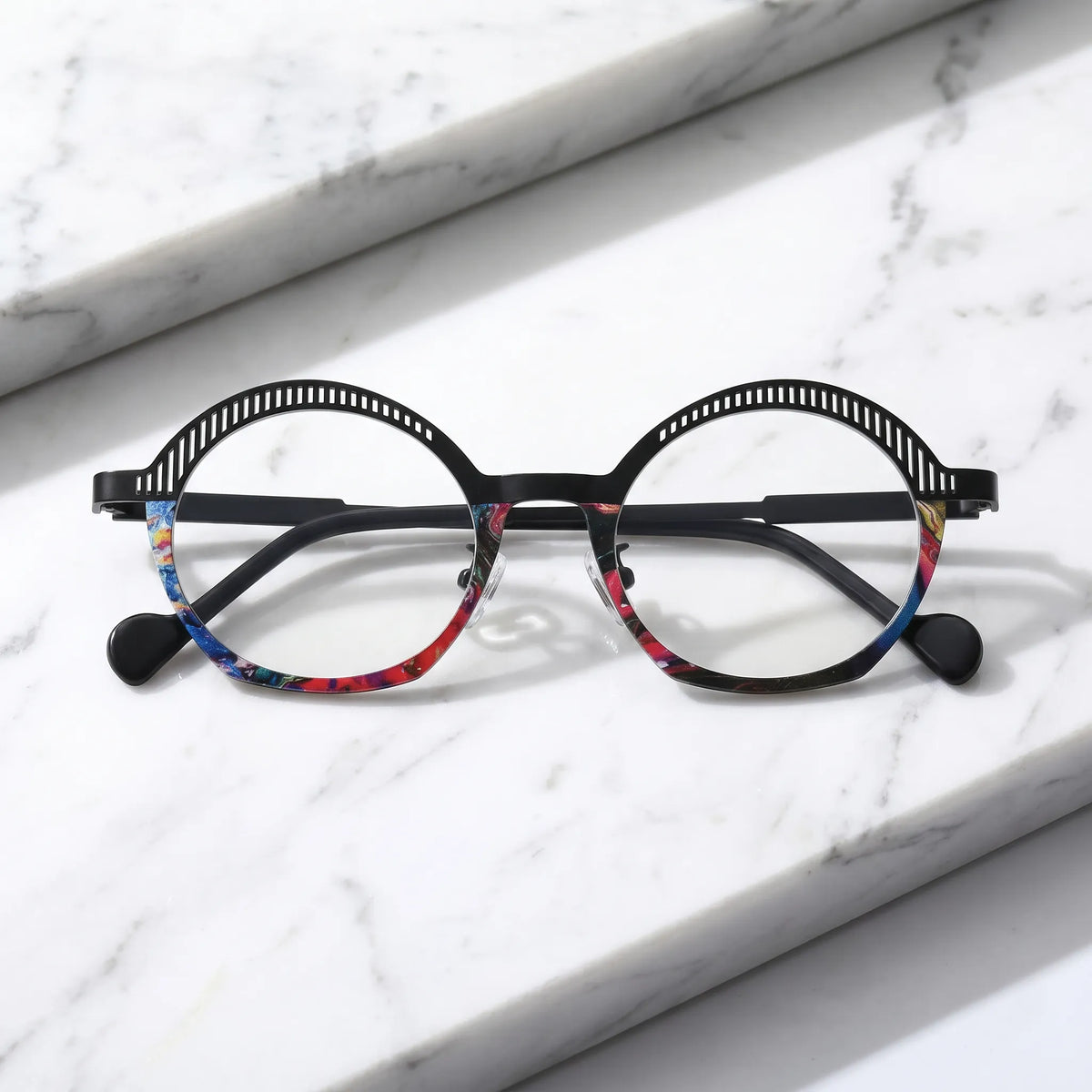Barledear Prism Noir eyeglasses folded display showing slim black titanium temples, clear nose pads, and artistic geometric oval frame