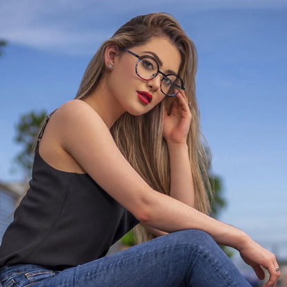 Model wearing Barledear Prism Noir eyeglasses in a lifestyle portrait with black titanium frame and colorful artistic rim accents