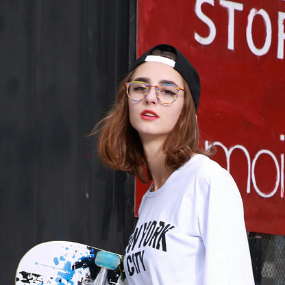 Model wearing Barledear Rainbow Stripe eyeglasses in a lifestyle portrait showing the retro oval acetate metal frame