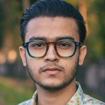 model wearing Barledear Teal Grove eyeglasses in a lifestyle portrait with retro square acetate frame