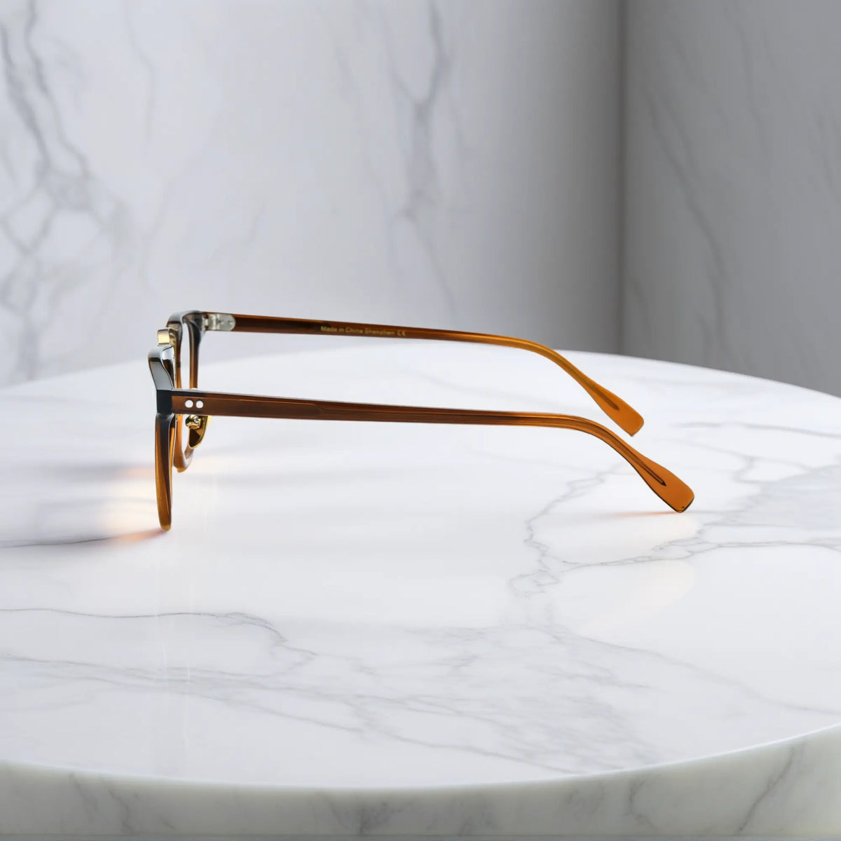 Side profile of VoyueLens VL19214 brown square eyeglasses highlighting slim temples and embedded metal hinge construction.