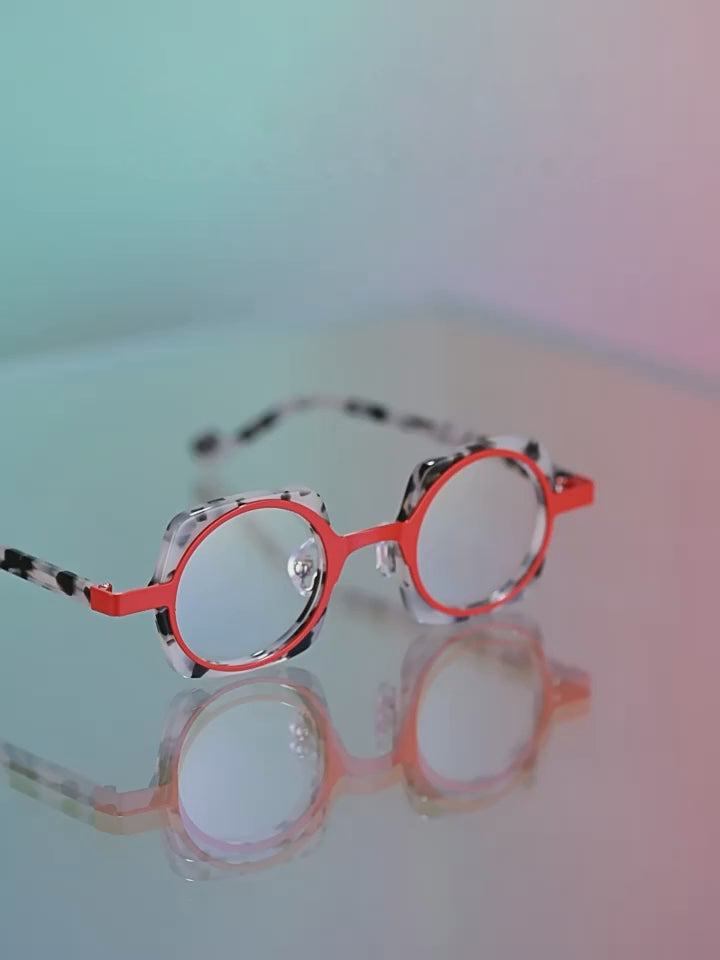 Close-up video of Barledear BD76869 layered geometric eyeglasses in ivory tortoise and crimson, showing the acetate and metal frame from multiple angles.