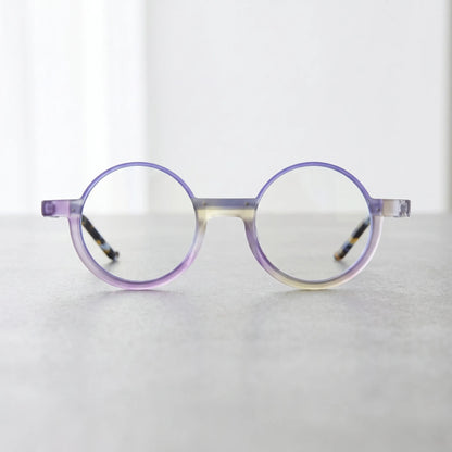 Front-facing view of VoyueLens Aurora Fade eyeglasses featuring a soft matte purple gradient and artistic round silhouette for expressive styling.