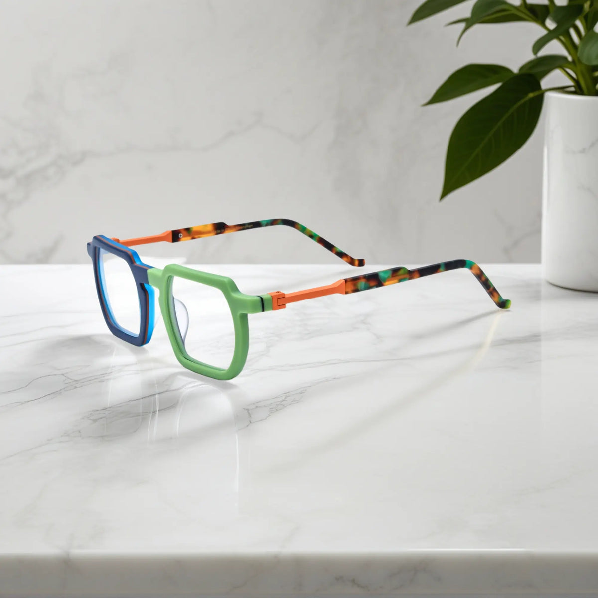 Side profile showing dual-tone blue-green acetate temples and artistic geometric design by VoyueLens