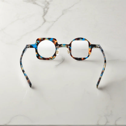 Back view highlighting the blue tortoise colorway of VoyueLens asymmetrical glasses with comfortable silicone pads and sturdy hinges.