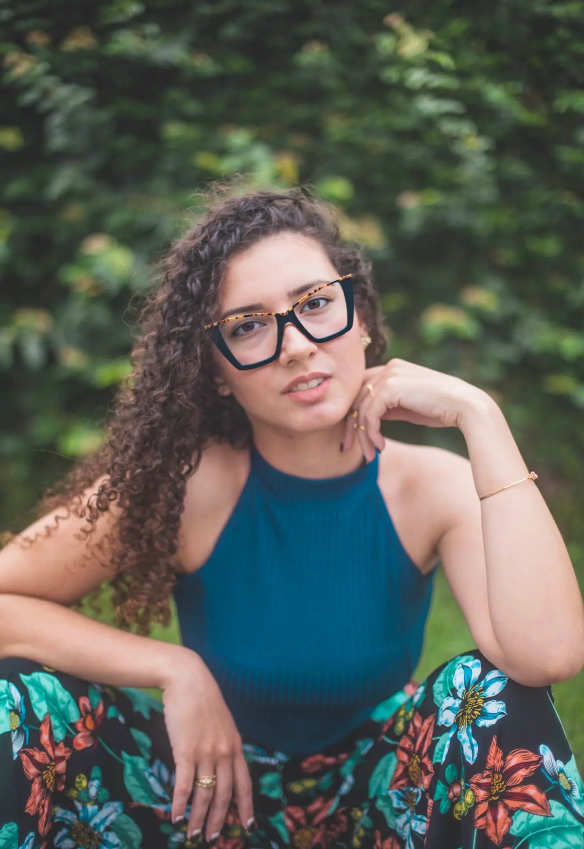 Fashion lifestyle image of a woman wearing Black-Blue Accent VoyueLens cat-eye glasses, combining professional elegance and youth style