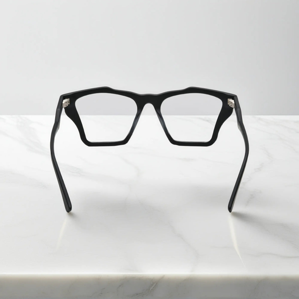 Rear view of VoyueLens Charcoal Black frame, displaying solid matte black with subtle gray temples from the inner frame and hinge area.