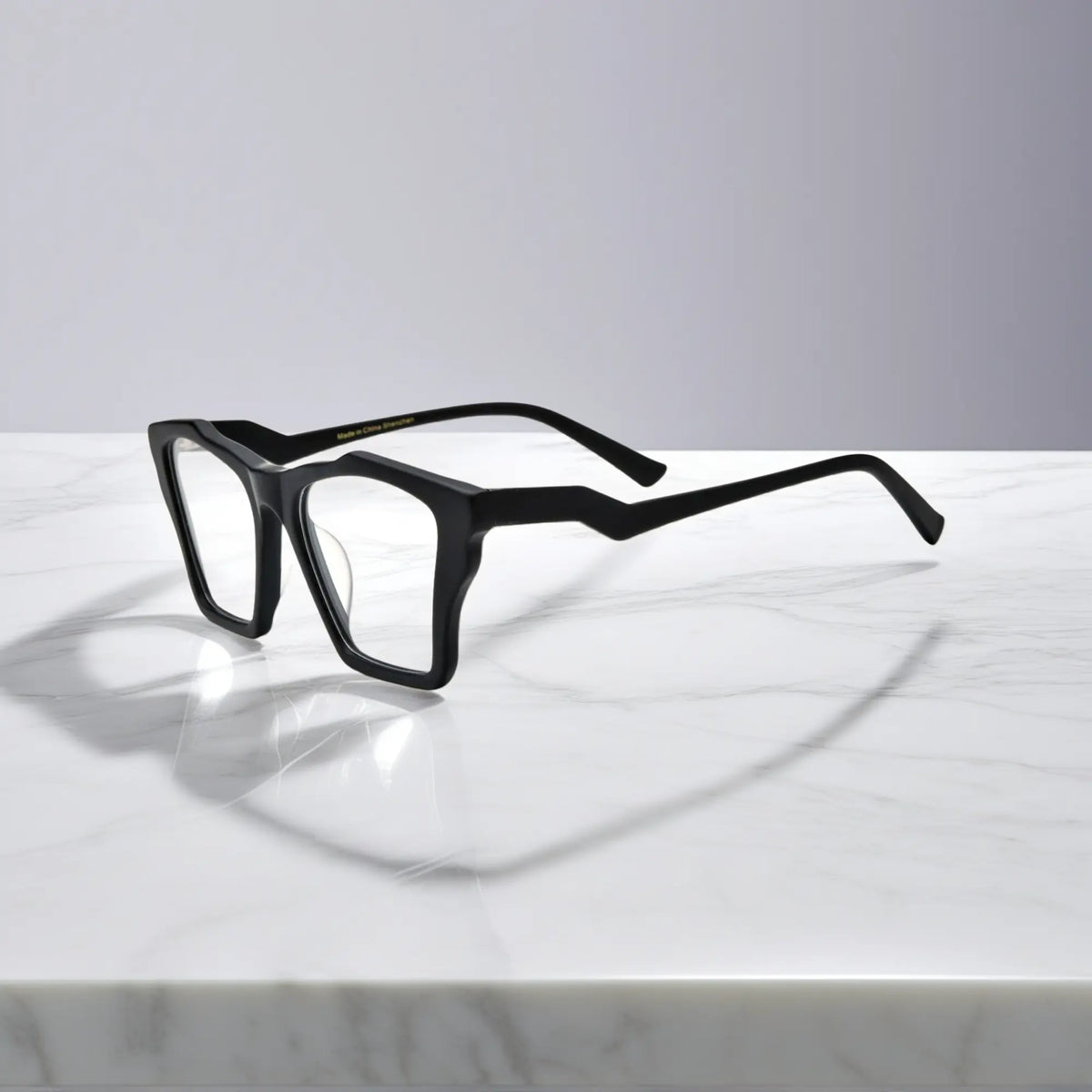 Side profile of VoyueLens Charcoal Black glasses, highlighting solid matte black with subtle gray temples and ergonomic acetate arms.