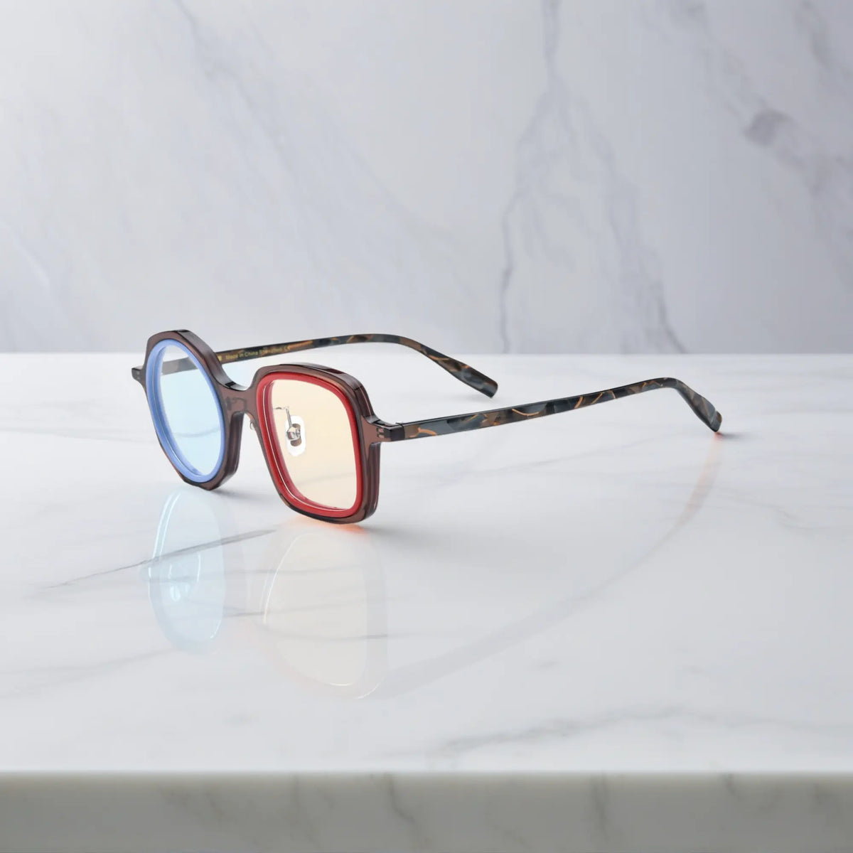 VoyueLens geometric eyeglasses in Chestnut Blue color, side view showing dual-tone design and spring hinges.