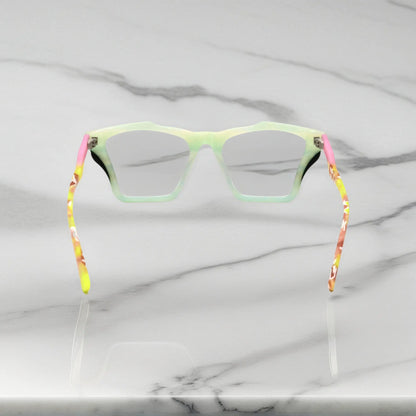 Rear view of VoyueLens Citrus Fade frame, displaying lime green front with pink-accented temples from the inner frame and hinge area.