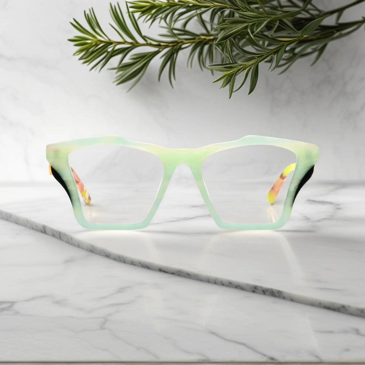 Front-facing view of VoyueLens Citrus Fade butterfly eyeglass frame featuring lime green front with pink-accented temples, showcasing its signature matte butterfly design.