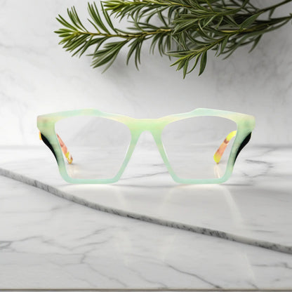 Front-facing view of VoyueLens Citrus Fade butterfly eyeglass frame featuring lime green front with pink-accented temples, showcasing its signature matte butterfly design.