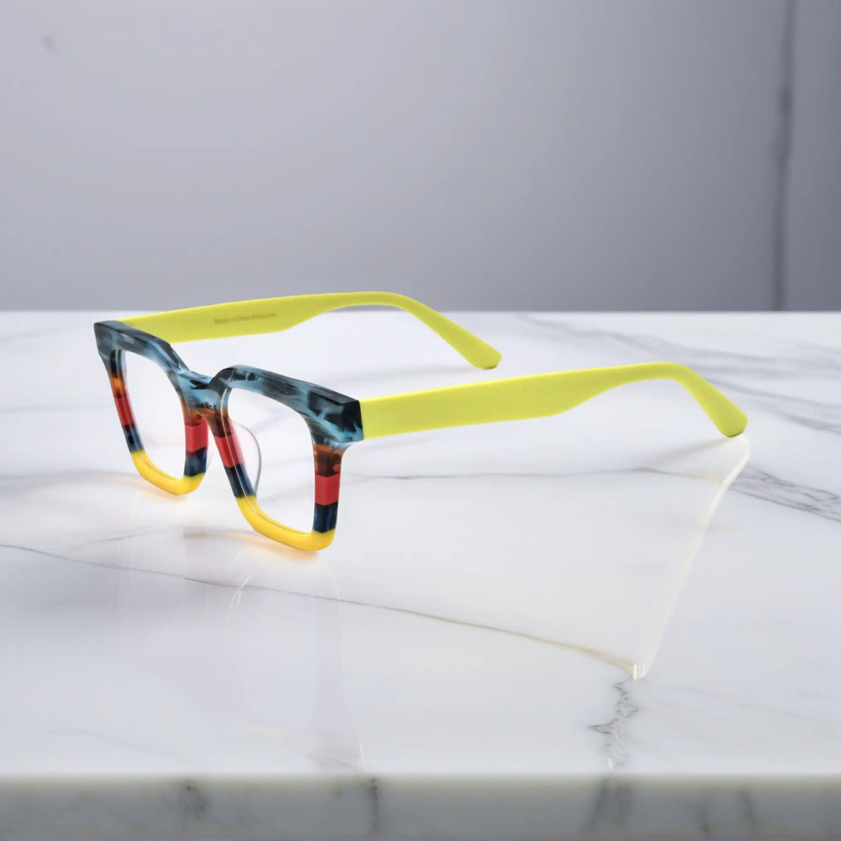 Side view of Citrus Fade eyeglasses with orange and yellow matte block pattern
