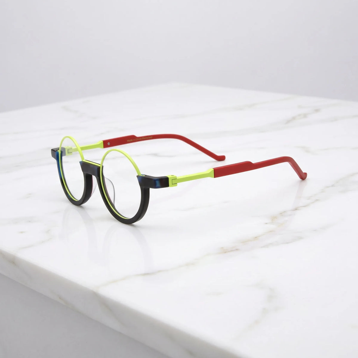 Side angle of Citrus Fade showing its zesty lime hues and fluid round contours in acetate form.