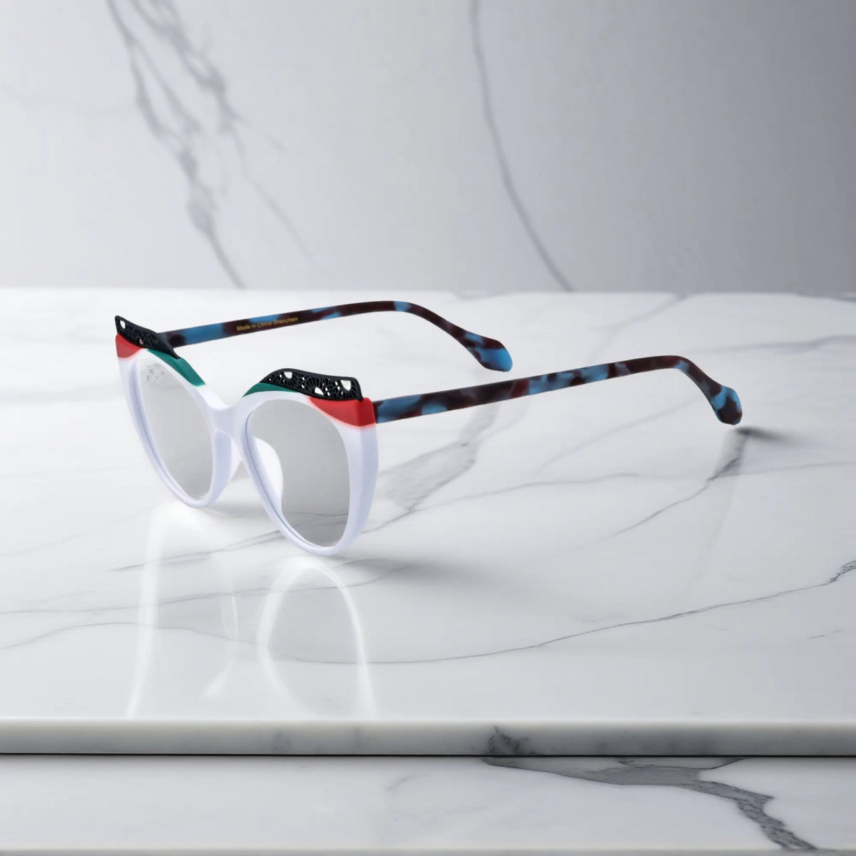 Side View of VoyueLens Ice Coral cat-eye eyeglasses with frosty white-to-coral fade and signature lace-pattern design.