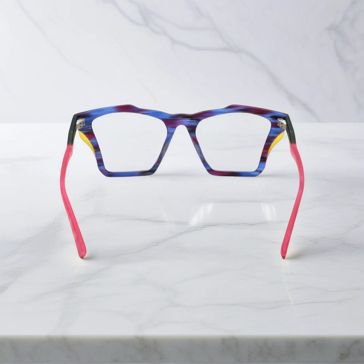 Rear view of VoyueLens Indigo Wave frame, displaying matte striped indigo with flowing tonal patterns from the inner frame and hinge area.