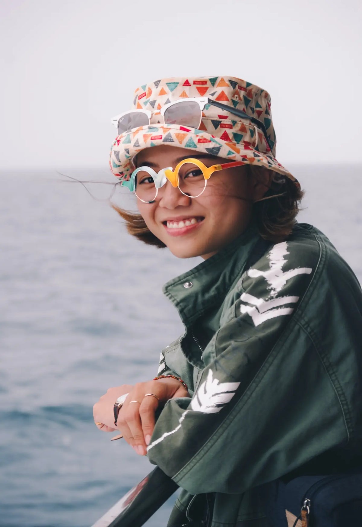 Outdoor model wearing VoyueLens Ivory-Orange semi-rimless browline eyeglasses, demonstrating stylish matte frame fit.
