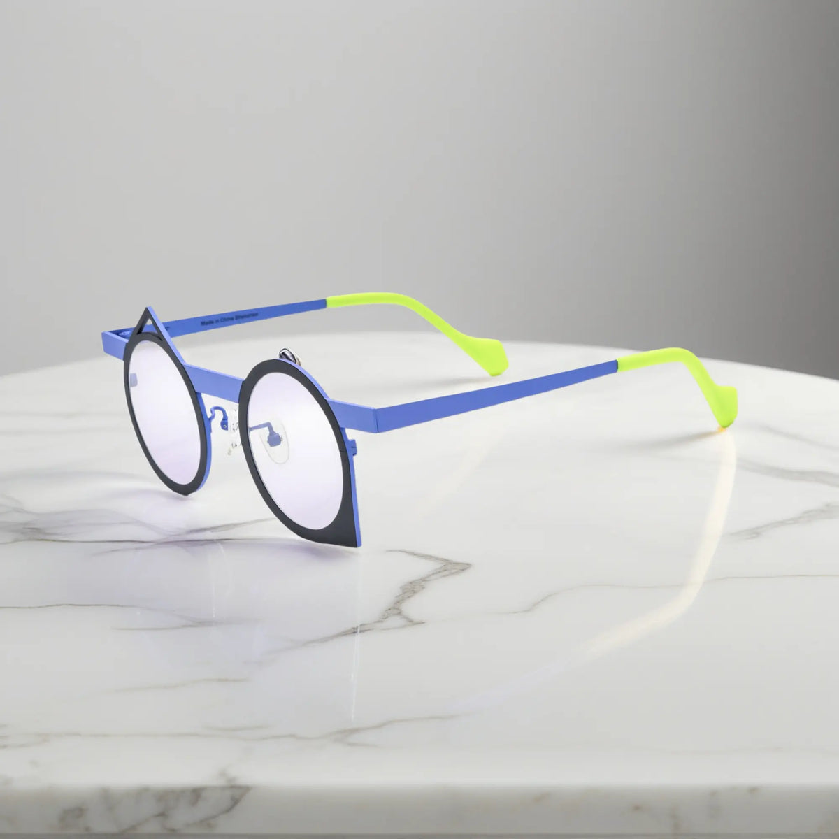 Side profile of VoyueLens Midnight Neon titanium eyeglasses highlighting its bold artistic polygonal structure.