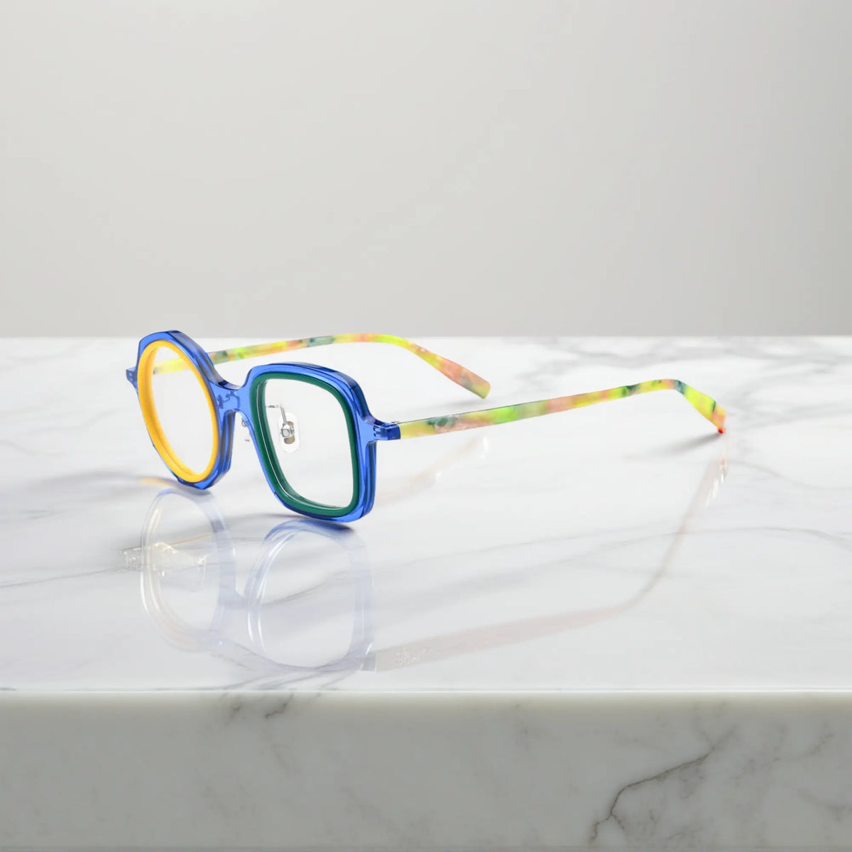 VoyueLens geometric eyeglasses in Navy Lemon color, side view showing dual-tone design and spring hinges.