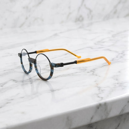 Side profile showcasing marine green tortoiseshell arms with classic round frame aesthetics.