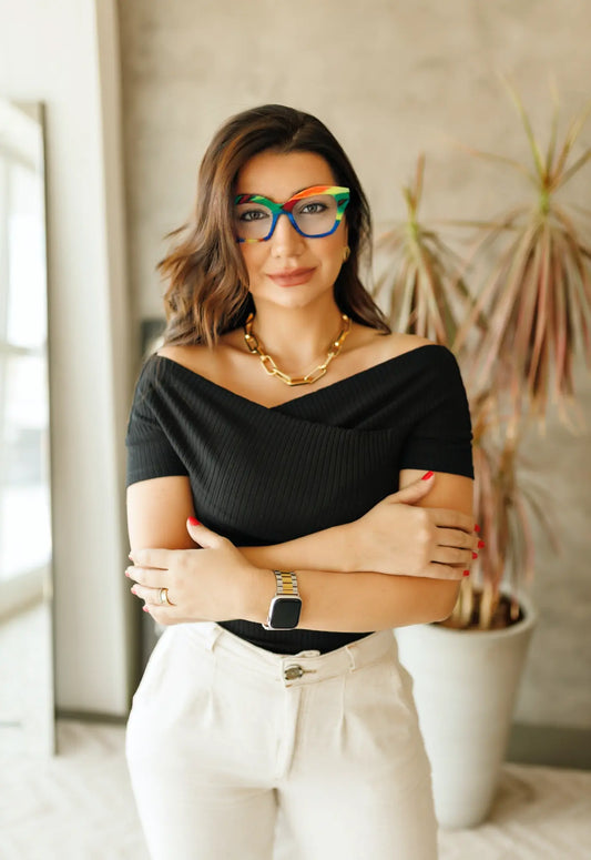 Fashion model wearing VoyueLens Rainbow Cream eyeglasses styled for pastel streetwear and soft statement look.