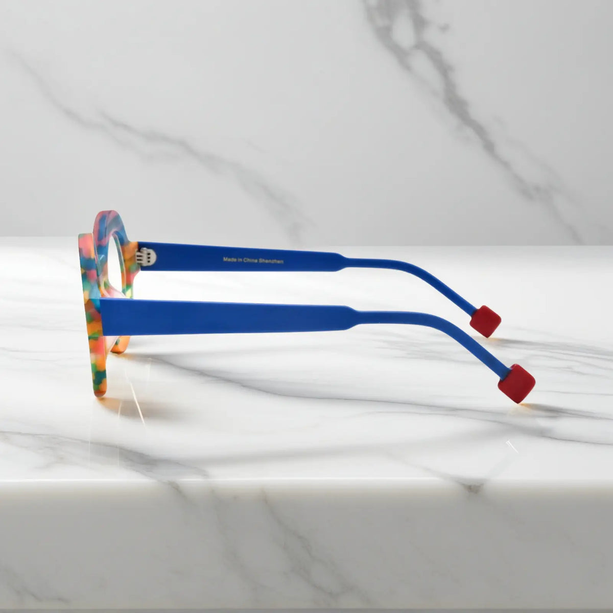 Side profile of Rainbow Stripe VoyueLens VL19355 glasses showing multi-color matte acetate temples and geometric polygon silhouette