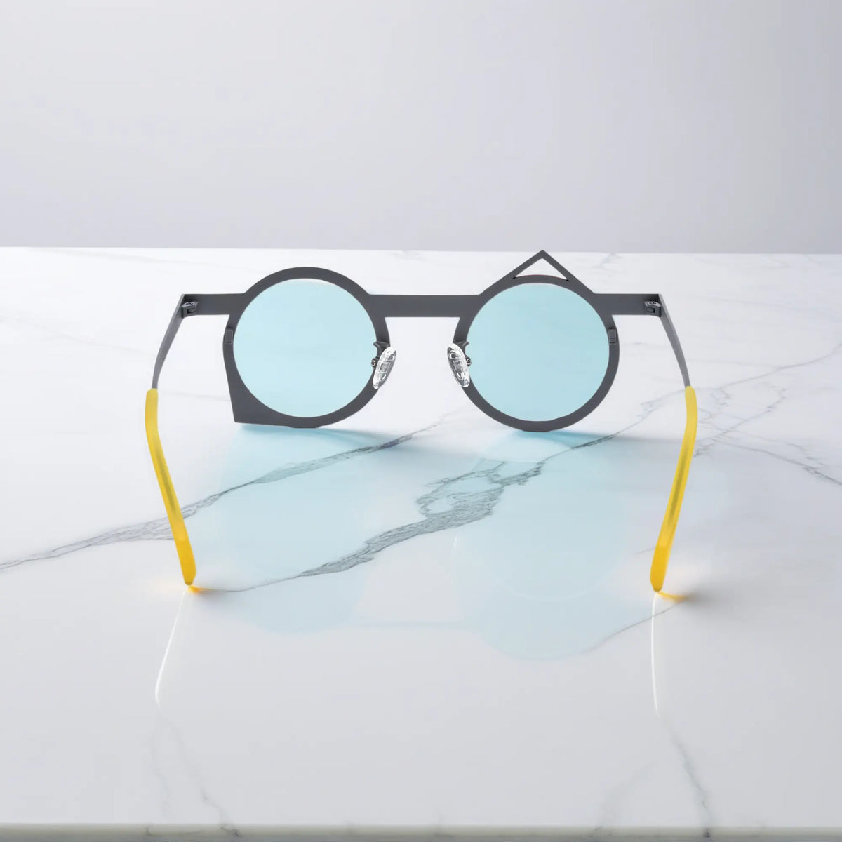 Rear perspective of VoyueLens VL185801 red-grey polygonal glasses made of corrosion-resistant, lightweight titanium.
