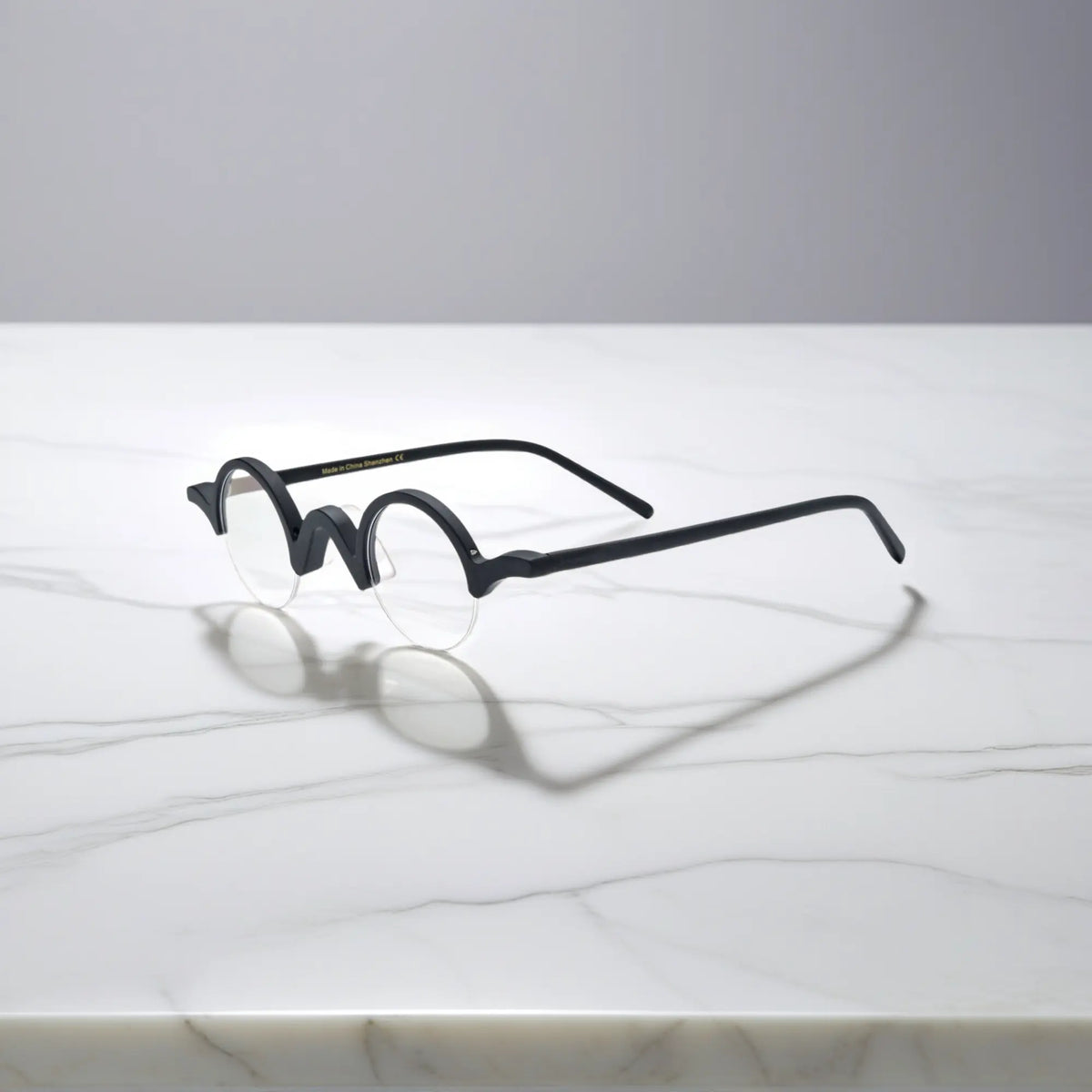 Side look at VoyueLens Solid Black semi-rimless browline eyeglasses, focusing on bold black matte acetate frame.