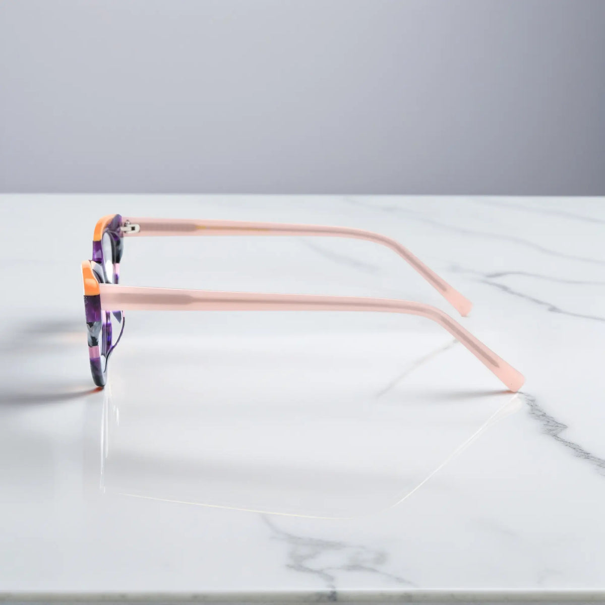 Side profile of VoyueLens Violet Garden cat-eye eyeglasses showing soft pink temples
