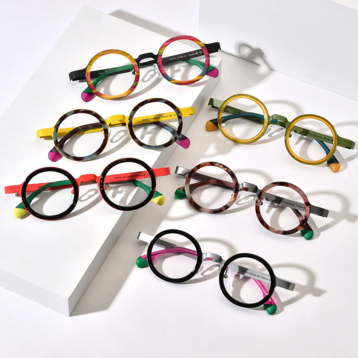 Full collection of VoyueLens VL185816 round titanium eyeglasses in six color variants arranged in flatlay display