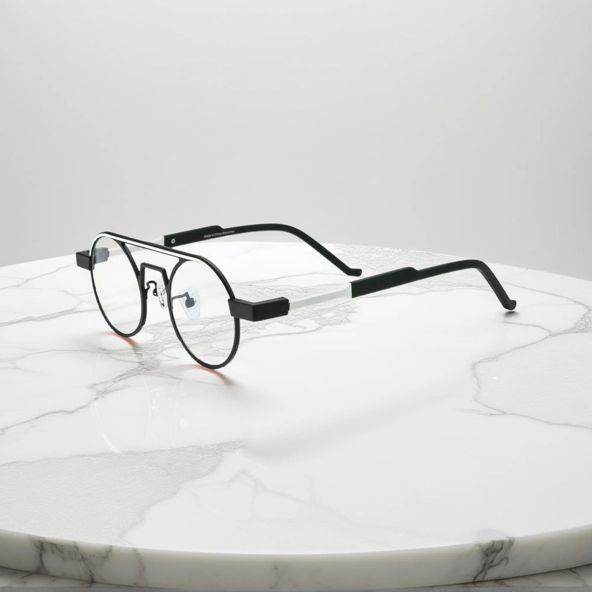 Side profile showing the slim titanium arms and hinge structure in Graphite Black matte titanium frame for a modern minimalistic look