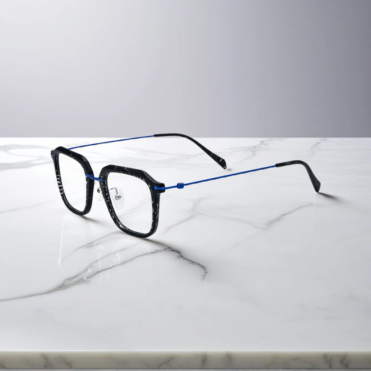 Sleek side view of the black frame with cool-toned titanium temple detailing.