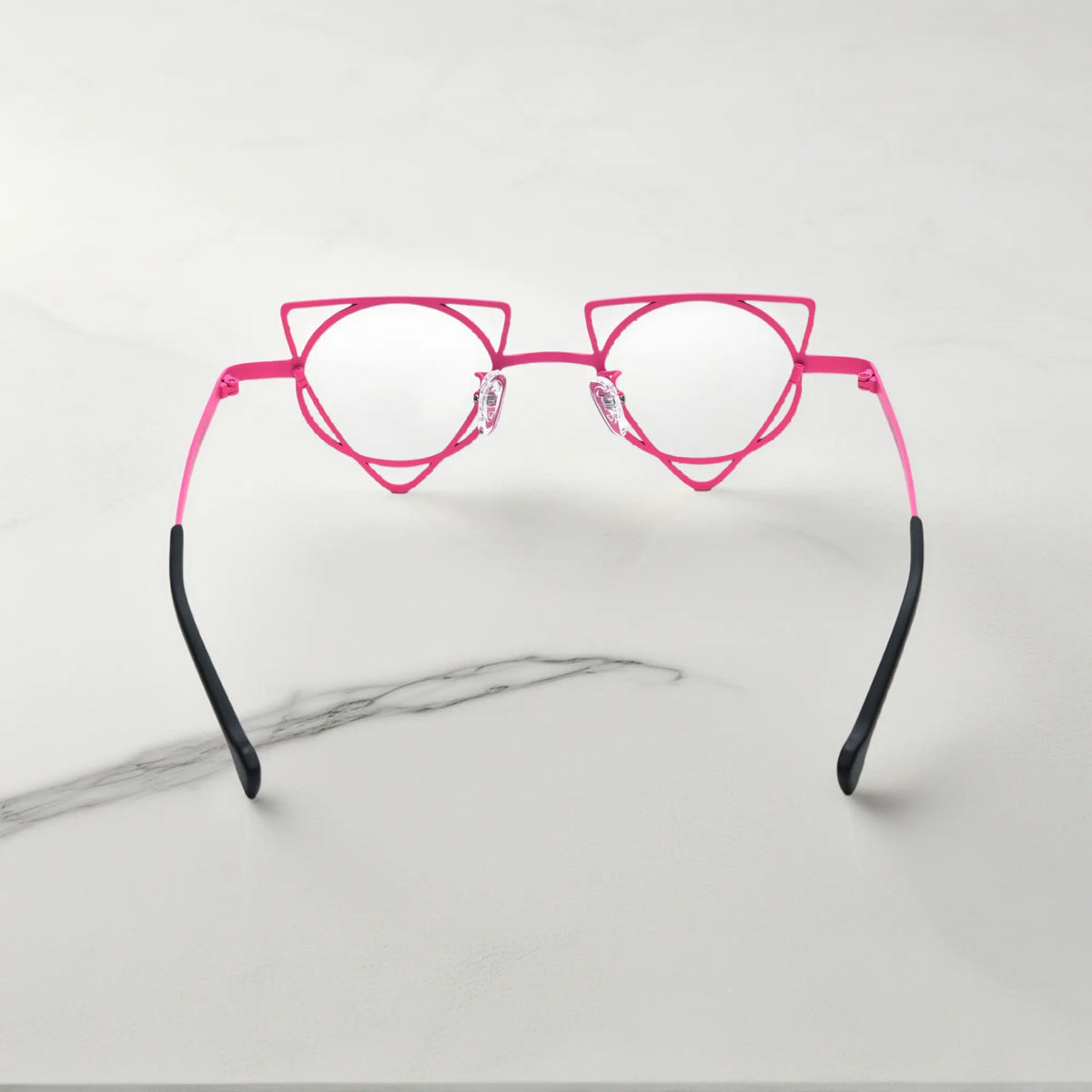 Back angle revealing artistic frame curves of VoyueLens Fuchsia Lime geometric glasses, crafted from lightweight titanium