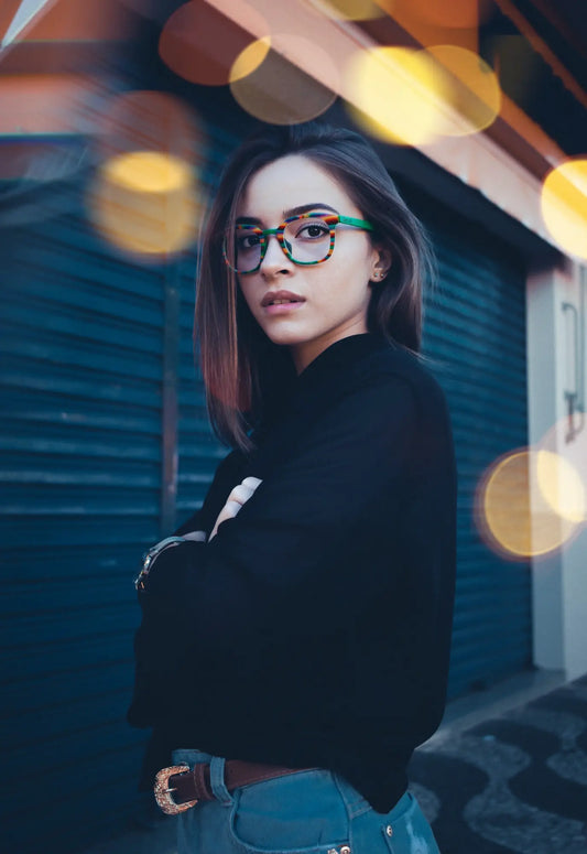 Model wearing VoyueLens Aurora Stripe square eyeglasses with a green-to-clear gradient acetate front and satin titanium temples.