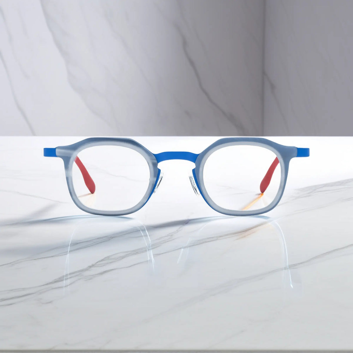 Front view of VoyueLens Ocean Signal square eyeglasses with a deep blue acetate front and vibrant red titanium temples.