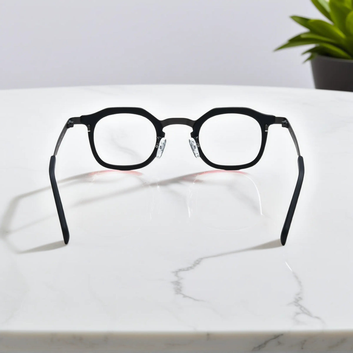 Rear view of VoyueLens Graphite Mist eyeglasses showing a matte grey acetate front and black titanium temples.