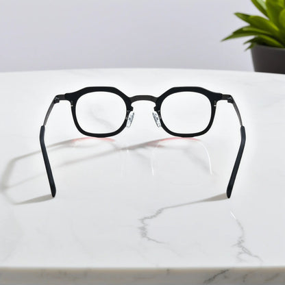 Rear view of VoyueLens Graphite Mist eyeglasses showing a matte grey acetate front and black titanium temples.