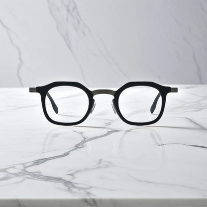 Front view of VoyueLens Graphite Mist square eyeglasses with a matte grey acetate front and black titanium temples.
