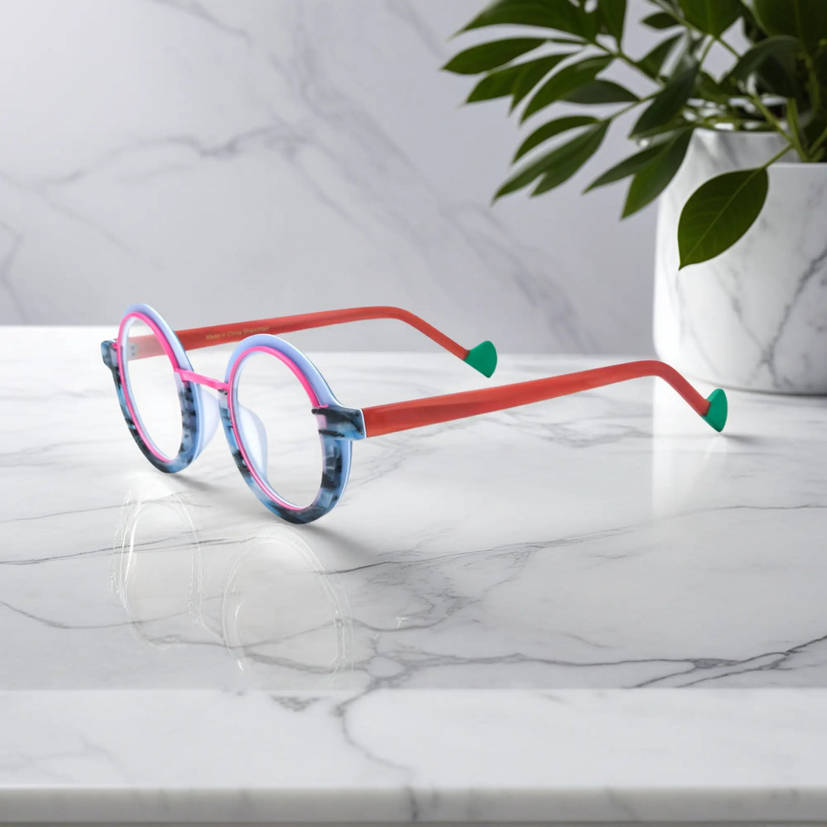 Side angle of VoyueLens eyeglass frames in Blue Coral highlighting temple structure and artistic design.