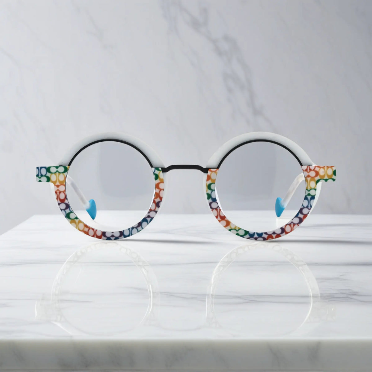 Front view of VoyueLens Chromatic Orbit Eyeglasses in Mosaic Frost showcasing its bold round silhouette and vibrant color scheme.